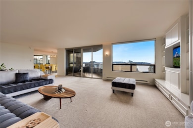 Expansive living room with westerly views to the sound & Olympic Mountain range.
