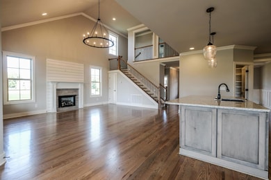 Great Room offers shiplap trim around the fireplace, as well as a closet under the stairs.