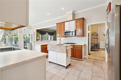 Kitchen with double ovens, gas cooktop & stone cou