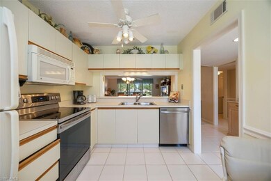 Kitchen featuring light tile patterned flooring, light countertops, visible vents, appliances with stainless steel finishes, and a sink