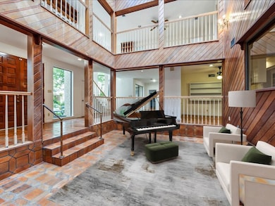 Atrium virtually staged as music room.