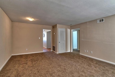 Carpeted spare room with a textured ceiling