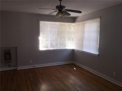 Unfurnished room with ceiling fan, heating unit, w