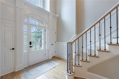 Light filled foyer with Wrought Iron railings