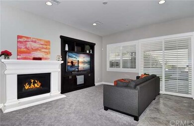 As you enter into the rear portion of the home you are welcomed by the large great room. Part of that great room is the family room as you see in this photo. A gorgeous gas burning fireplace, large windows and built in entertainment unit are present.