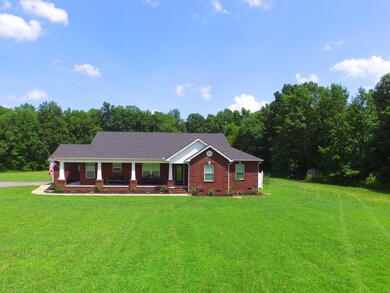 Larger view of the front yard and this stunning custom built home. 