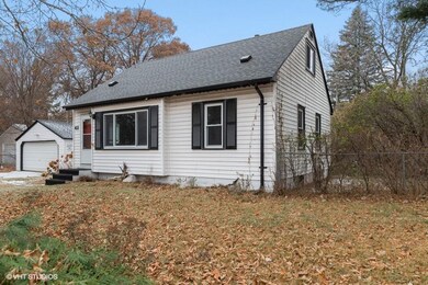 Detached 2 car garage with wide driveway.