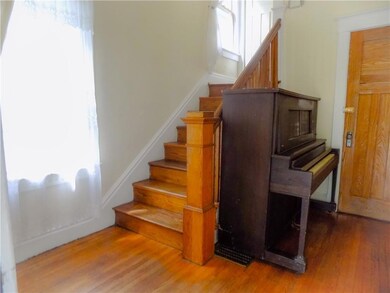 Foyer/ Entrance to Upper Unit. Door leads to side entrance and basement.