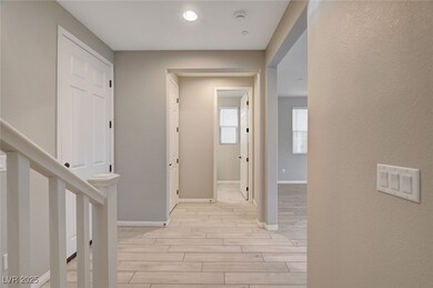 Corridor with stairs, baseboards, and wood tiled f