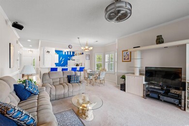 Living area with crown molding, light colored carp