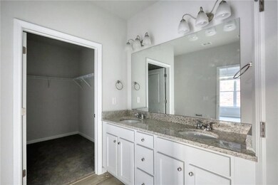 Full bath with a sink, double vanity, and a spacio