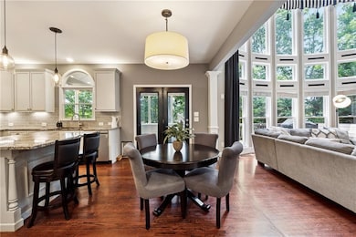 Dining area with dark wood-type flooring