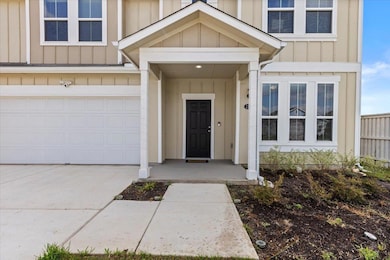 View of exterior entry with board and batten sidi