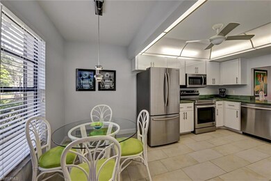 Kitchen with white cabinetry, light tile patterned