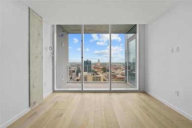Empty room featuring baseboards, wood finished fl