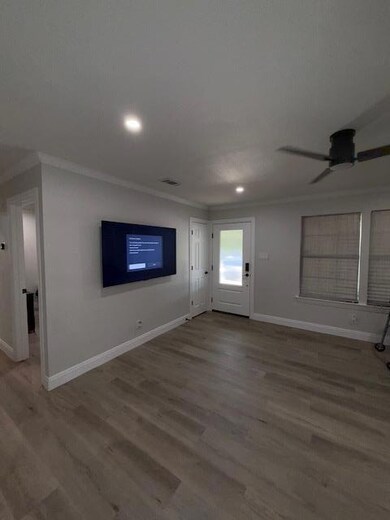 Unfurnished living room featuring ornamental mold