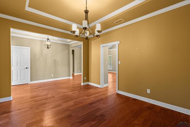 Empty room with hardwood / wood-style flooring, or