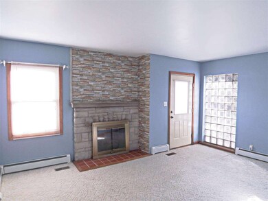 The open floor plan offers a living room with fire