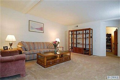 Living room next to 1/2 bath and downstaris BR/den