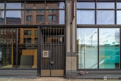 An unassuming entry to a beautiful building. Commercial tenants/gallery to the right