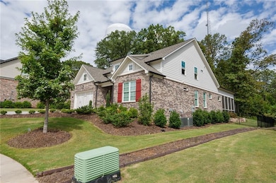 View of front facade with brick siding and roof with shingles