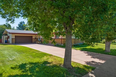 View of front of house featuring a garage, a front yard, and driveway