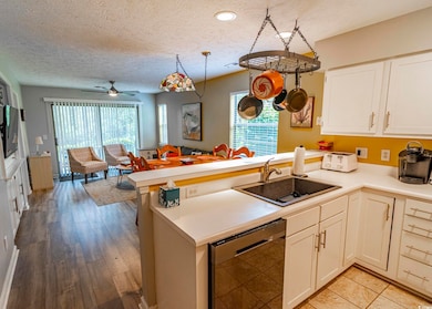 Kitchen with a peninsula, a sink, a textured ceili