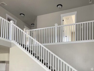 Staircase with carpet and a high ceiling