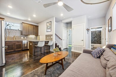 Living room with visible vents, recessed lighting