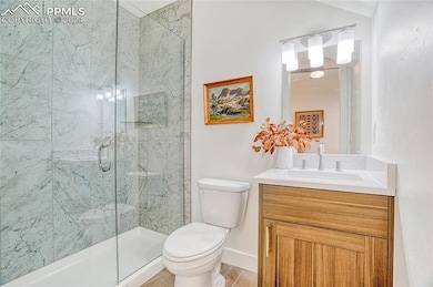 Bathroom with tile patterned flooring, vanity, toi