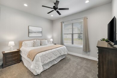 Bedroom with carpet, recessed lighting, and a ceiling fan