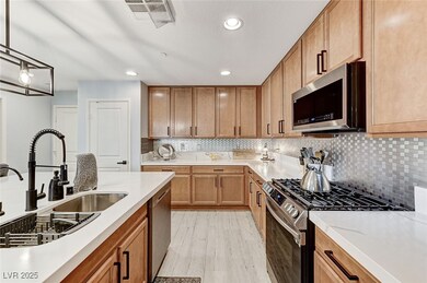 Kitchen with stainless steel appliances, tasteful backsplash, light countertops, recessed lighting, and light wood-style flooring
