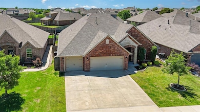 View of front of home featuring brick siding, a garage, a residential view, concrete driveway, and a front lawn