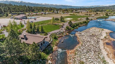 Bird's eye view of a heavily wooded area and a water and mountain view
