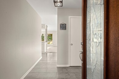 This is a well-lit entryway with neutral walls and