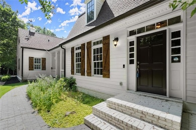 Doorway to property with a shingled roof
