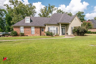 View of front of house featuring french doors, roof with shingles, a front lawn, brick siding, and stucco siding