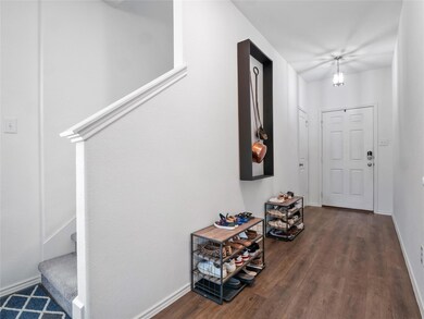 Corridor with wood finished floors, baseboards, a