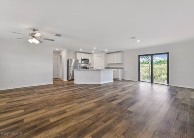 Unfurnished living room featuring dark wood finish