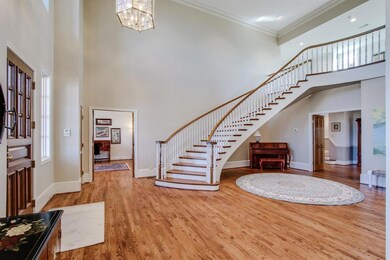 This living area has refinished wood flooring and a grand entry. The stairs lead to the two very large bedrooms that have their own private baths. The room to the far back is a den currently being used as a double his/her office.