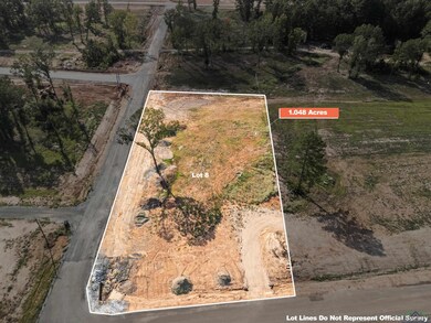 Aerial view of property and surrounding area featuring property parcel outlined and rural landscape