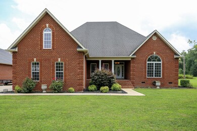 Beautiful landscaping & front sidewalk leading to covered front porch.