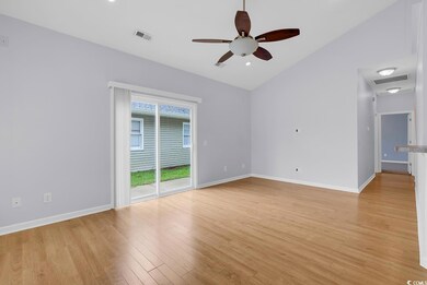 Unfurnished room featuring lofted ceiling, a ceiling fan, and light wood-style floors
