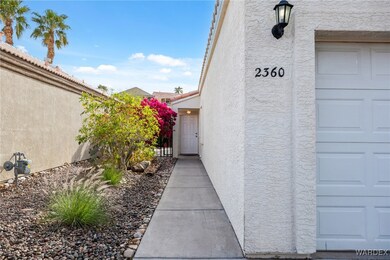 Doorway to property with a garage, stucco siding,
