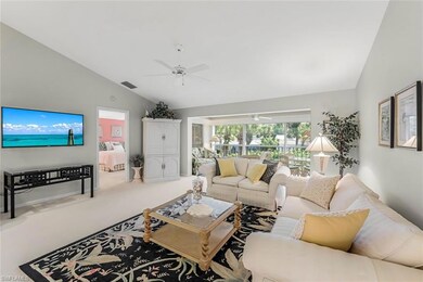 Carpeted living room featuring high vaulted ceilin