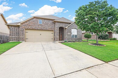 View of front facade featuring a front lawn, a garage, and central AC unit