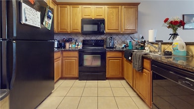 Kitchen featuring black appliances, beverage coole