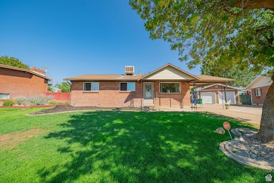 Ranch-style house featuring brick siding and concrete driveway