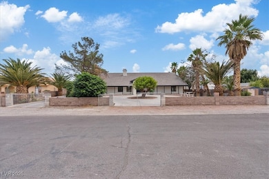 Single story home with a fenced front yard and a gate