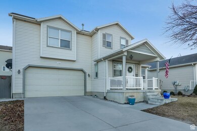 View of front facade featuring a porch and a garage